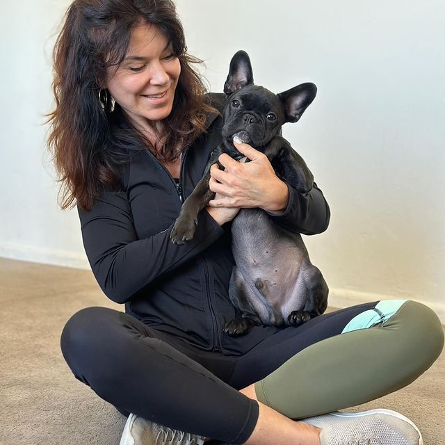 Liarne sitting with a small black dog